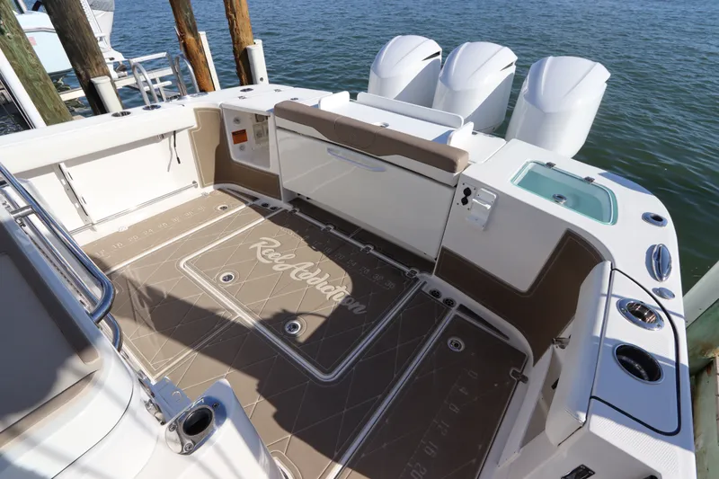 Slide: The Image of Edgewater 370CC 2021 boat deck with triple engines and fishing amenities. - 6