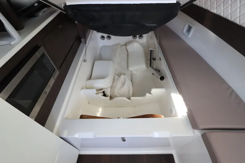 Slide: The Image of Interior view of 2021 Edgewater 370CC boat cabin with seating and storage. - 59