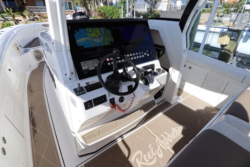 Slide: The Image of 2021 Edgewater 370CC boat cockpit with advanced navigation system and steering wheel. - 32