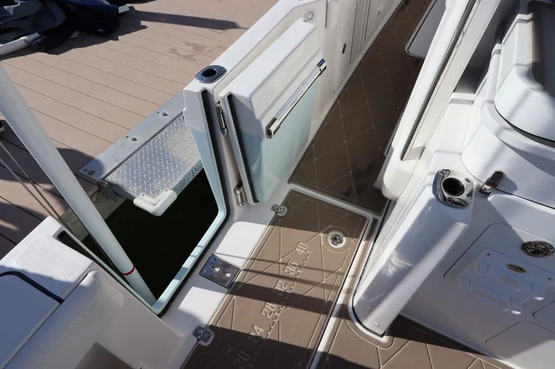 Slide: The Image of 2021 Edgewater 370CC boat deck with open side door and non-slip flooring. - 22