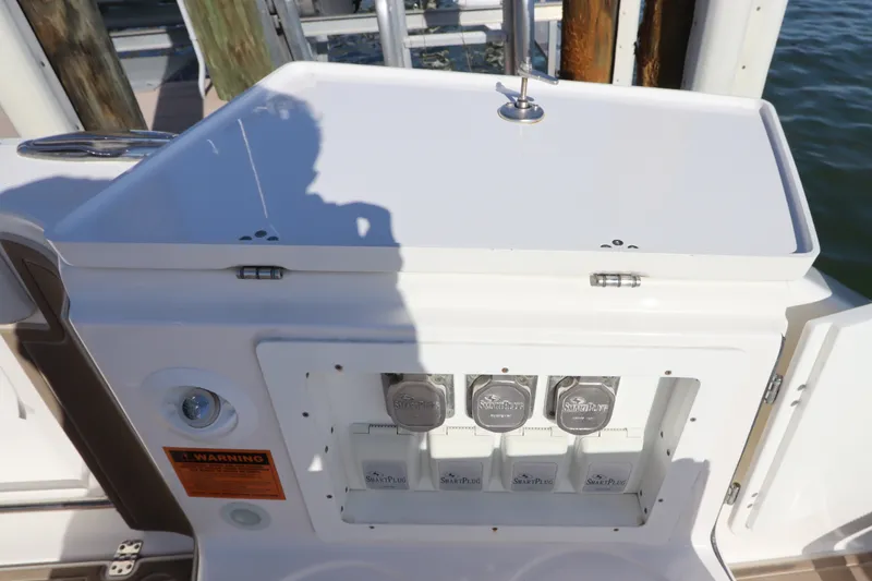 Slide: The Image of Edgewater 370CC 2021 boat electrical panel with SmartPlug connectors and warning label. - 9