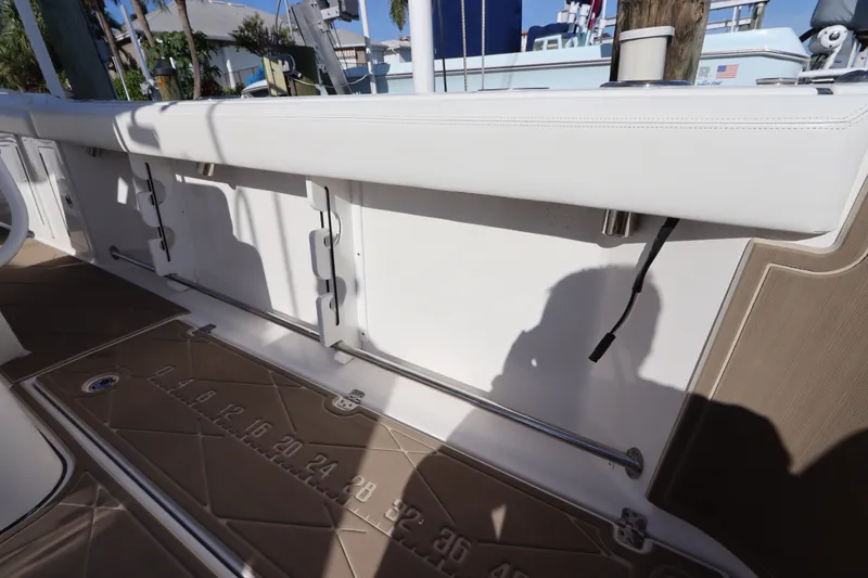 Slide: The Image of 2021 Edgewater 370CC boat interior with white seating and brown flooring. - 21