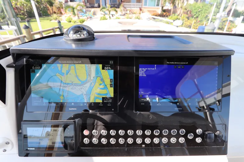 Slide: The Image of Edgewater 370CC 2021 boat dashboard with navigation screens and controls. - 35