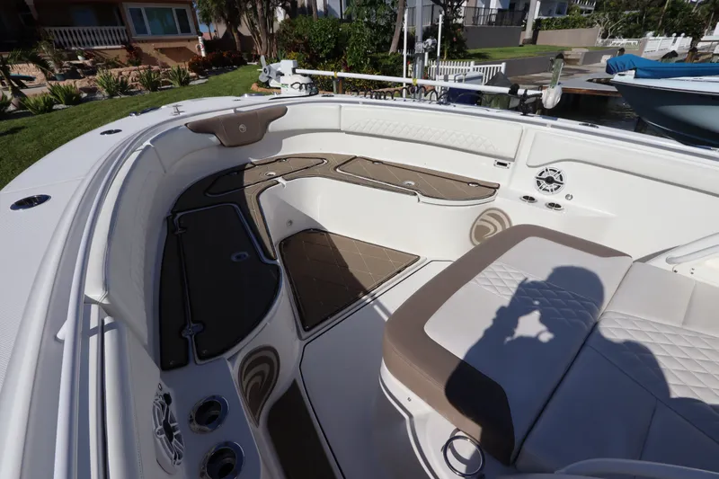 Slide: The Image of 2021 Edgewater 370CC boat interior with cushioned seating and deck details. - 40