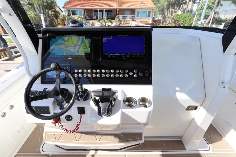 Slide: The Image of 2021 Edgewater 370CC boat helm with navigation screens and controls. - 33