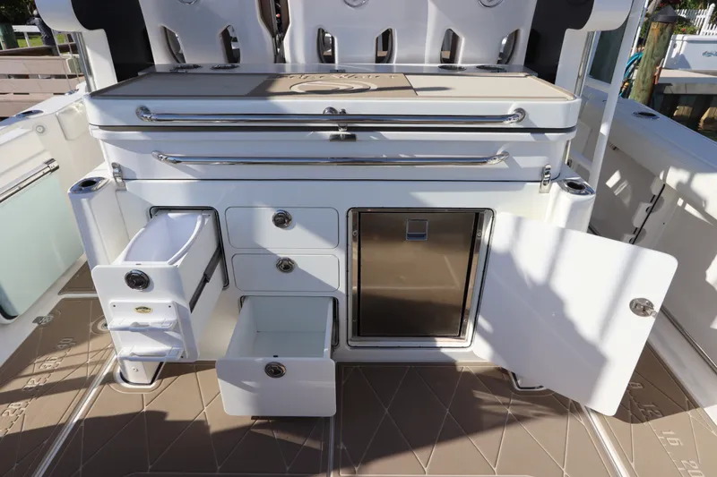 Slide: The Image of Edgewater 370CC 2021 boat interior with open storage compartments and drawers. - 28