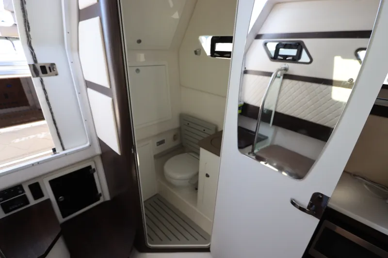Slide: The Image of Interior of a 2021 Edgewater 370CC boat featuring a compact bathroom with modern amenities. - 56