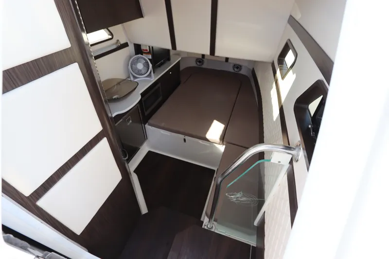 Slide: The Image of Interior cabin of 2021 Edgewater 370CC boat with bed, fan, and kitchenette. - 55