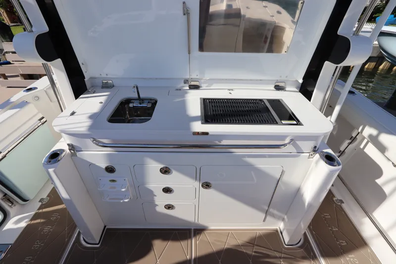 Slide: The Image of Outdoor kitchen on 2021 Edgewater 370CC boat with sink and grill. - 29