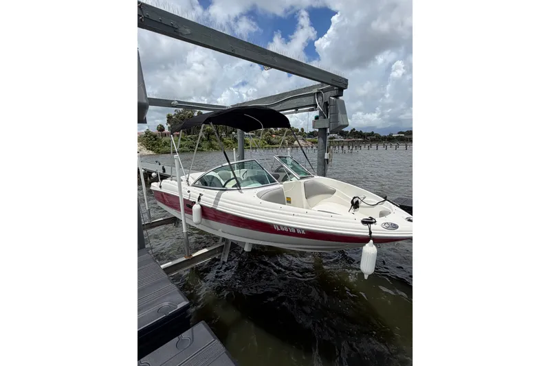 The Image of 2004 Sea Ray 180 Sport boat docked on a lift by the water. - 0