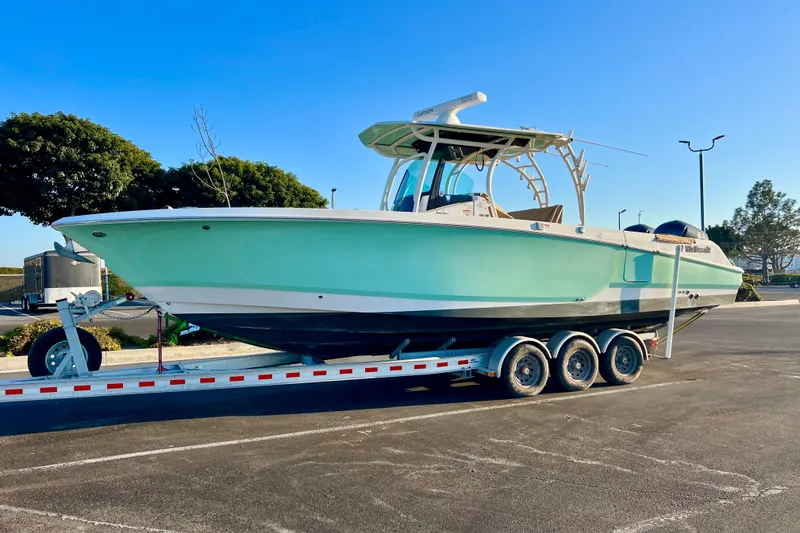 Slide: The Image of 2018 Wellcraft 302 Fisherman boat on a trailer in a parking lot. - 32