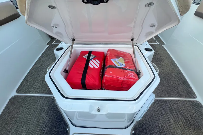 Slide: The Image of Open storage compartment on 2018 Wellcraft 302 Fisherman boat with red safety gear. - 27