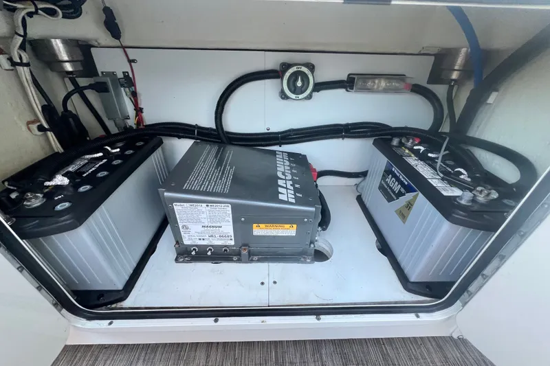 Slide: The Image of 2018 Wellcraft 302 Fisherman boat battery compartment with AGM batteries and Magnum Energy inverter. - 28