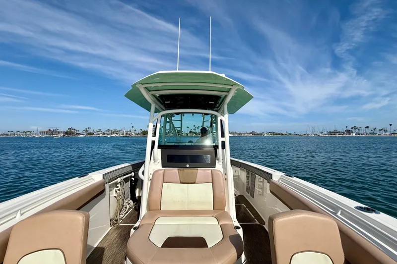 Slide: The Image of 2018 Wellcraft 302 Fisherman boat on calm water under a clear blue sky. - 16