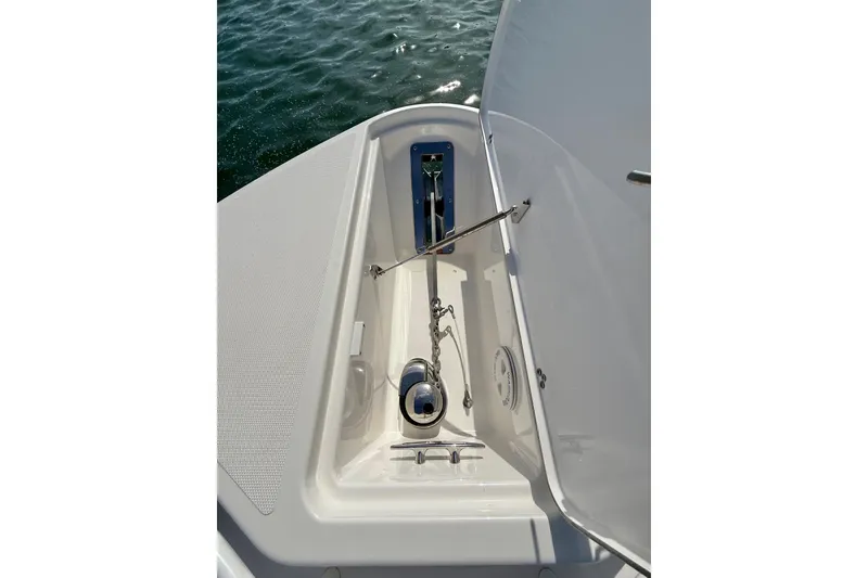 Slide: The Image of 2018 Wellcraft 302 Fisherman anchor compartment with open hatch, showing chain and winch. - 26