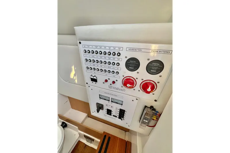 Slide: The Image of Control panel of 2018 Wellcraft 302 Fisherman boat, featuring battery switches and circuit breakers. - 30