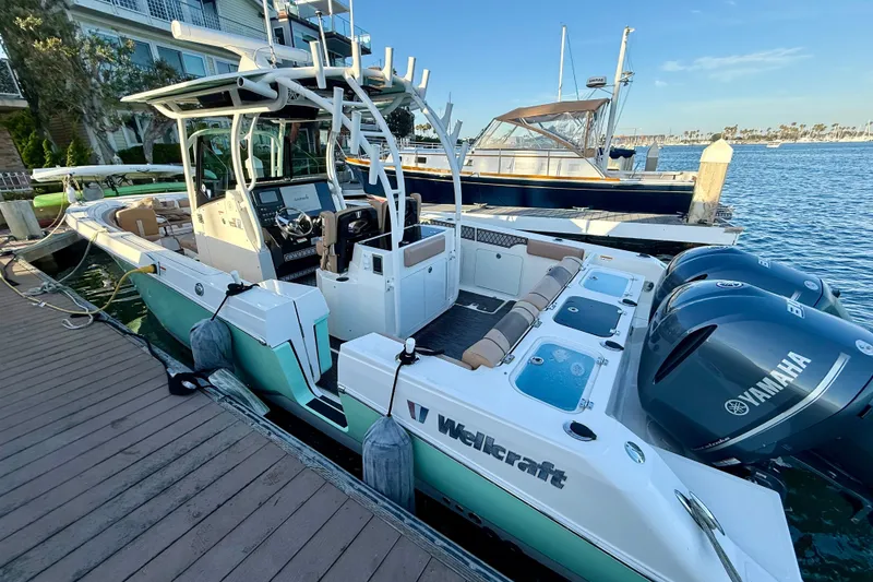 Slide: The Image of 2018 Wellcraft 302 Fisherman boat docked, featuring Yamaha engines and modern design. - 25