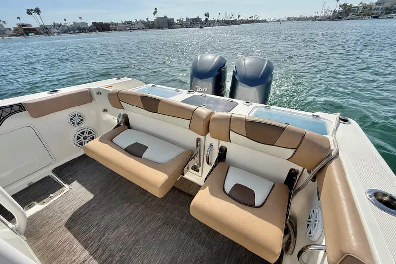 Slide: The Image of 2018 Wellcraft 302 Fisherman boat interior with dual engines, seating, and ocean view. - 21