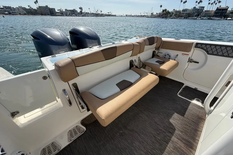 Slide: The Image of 2018 Wellcraft 302 Fisherman boat interior with seating and dual Yamaha engines. - 18