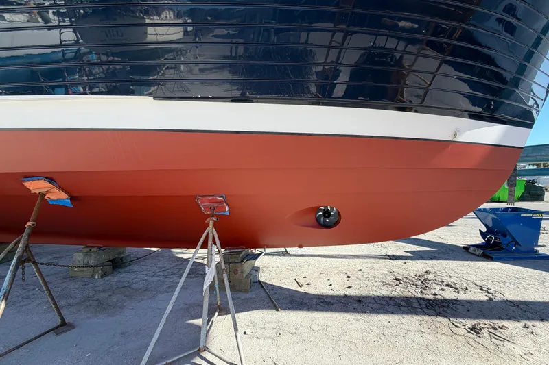 Slide: The Image of 2003 Grand Banks 64 Aleutian RP yacht hull on stands, showcasing sleek design. - 86