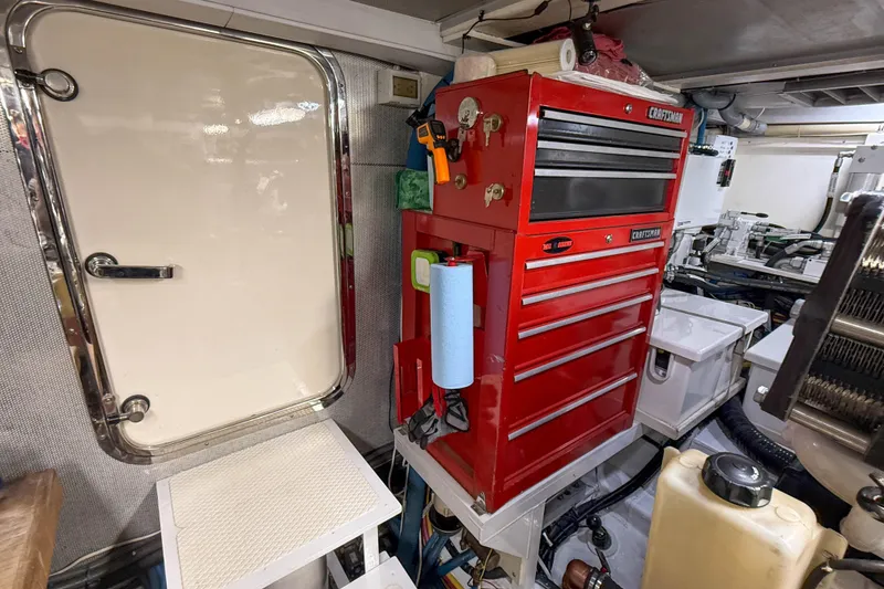 Slide: The Image of Engine room of 2003 Grand Banks 64 Aleutian RP with red tool chest and access door. - 80