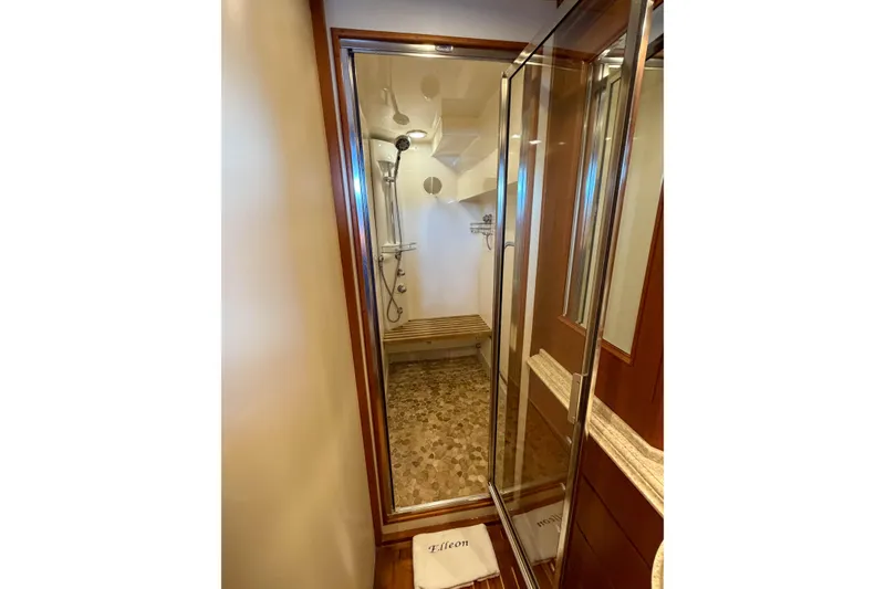 Slide: The Image of Luxurious shower area in 2003 Grand Banks 64 Aleutian RP yacht with glass door and wooden accents. - 50