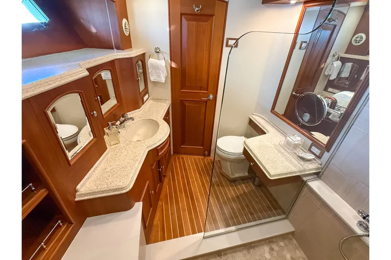 Slide: The Image of Luxurious bathroom in 2003 Grand Banks 64 Aleutian RP yacht with wood accents and modern fixtures. - 58