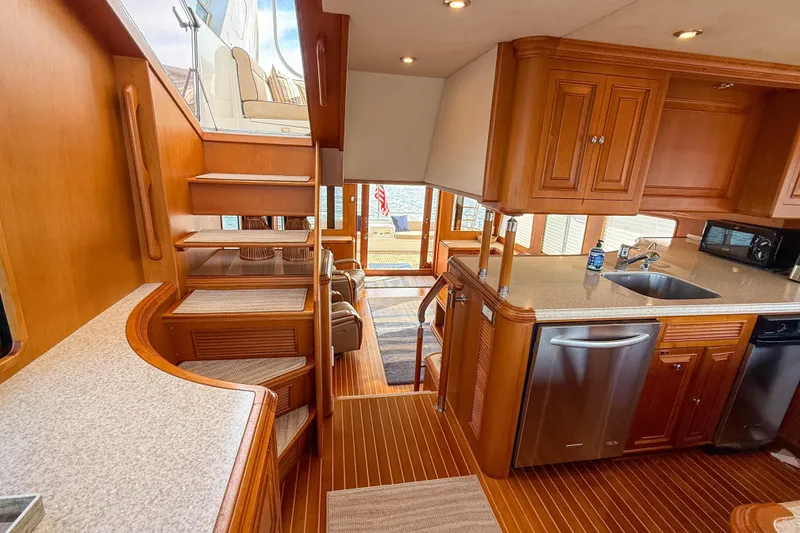 Slide: The Image of Luxurious 2003 Grand Banks 64 Aleutian RP yacht interior with elegant wood finishes and modern kitchen. - 16