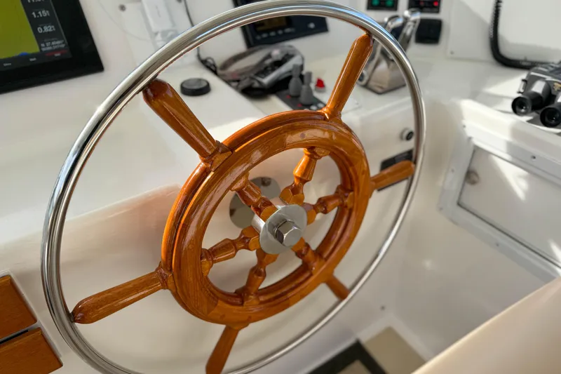 Slide: The Image of Wooden steering wheel on a 2003 Grand Banks 64 Aleutian RP yacht. - 31