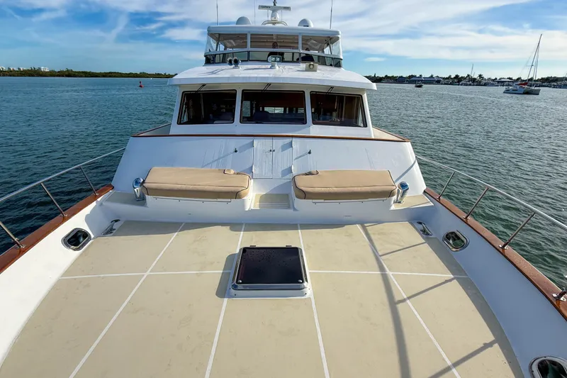 Slide: The Image of 2003 Grand Banks 64 Aleutian RP yacht on calm water, spacious deck view. - 70