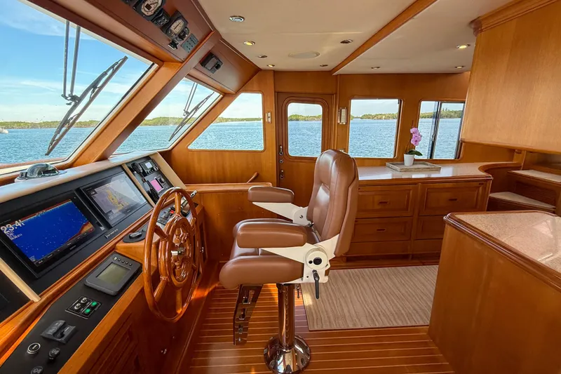 Slide: The Image of Luxurious helm of 2003 Grand Banks 64 Aleutian RP yacht with leather seating and navigation displays. - 24