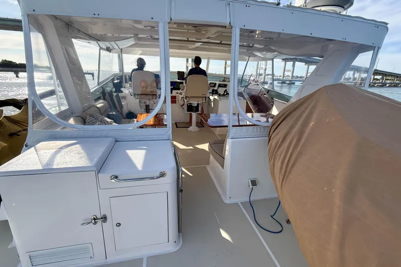 Slide: The Image of 2003 Grand Banks 64 Aleutian RP yacht cockpit with seating and helm station. - 35
