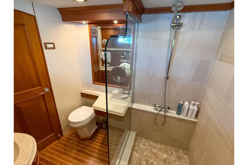 Slide: The Image of Luxurious bathroom on 2003 Grand Banks 64 Aleutian RP yacht with shower and wooden accents. - 57