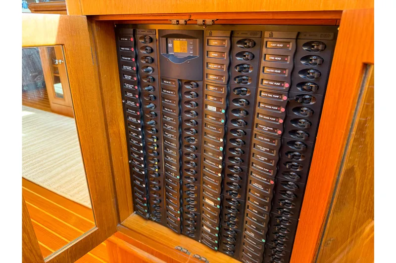 Slide: The Image of Electrical panel inside 2003 Grand Banks 64 Aleutian RP yacht, showcasing circuit breakers. - 84