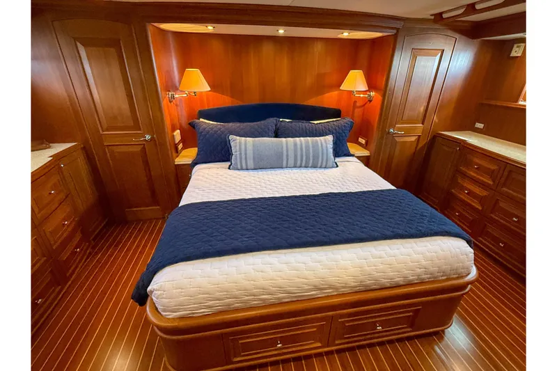Slide: The Image of Luxurious 2003 Grand Banks 64 Aleutian RP yacht bedroom with elegant wood finish and cozy bedding. - 42