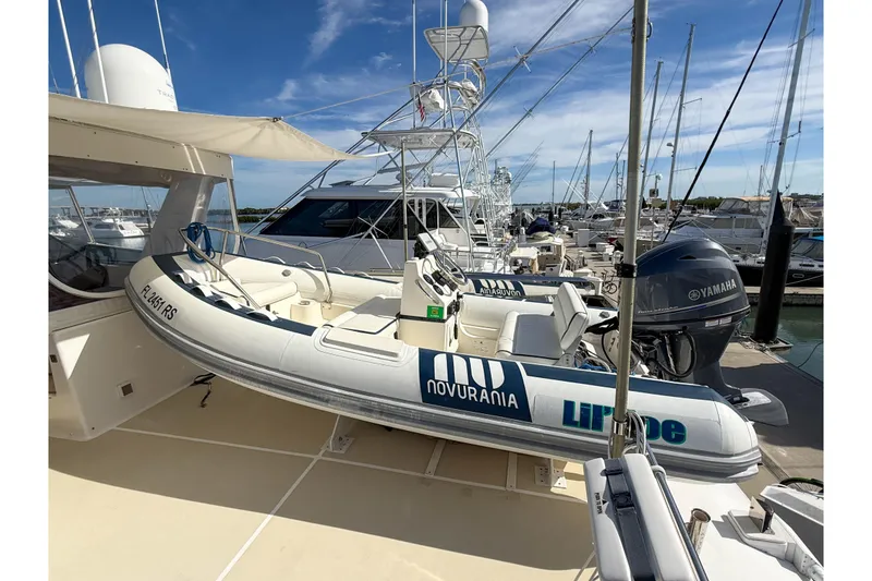 Slide: The Image of 2003 Grand Banks 64 Aleutian RP with Novurania tender and Yamaha outboard at marina. - 36