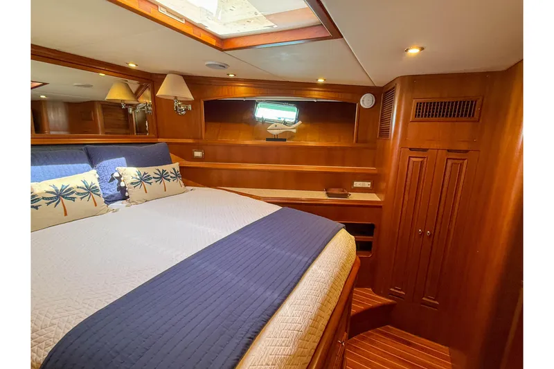 Slide: The Image of Luxurious cabin interior of 2003 Grand Banks 64 Aleutian RP yacht, featuring elegant wood finishes. - 54