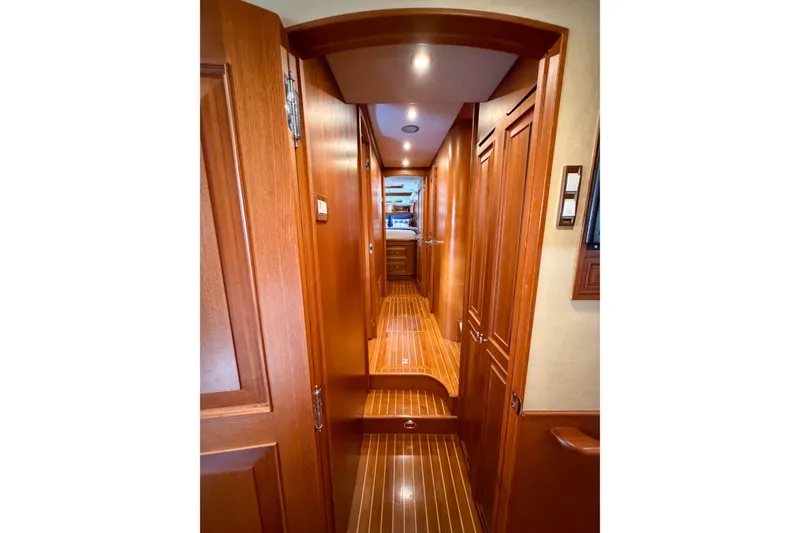Slide: The Image of Interior hallway of 2003 Grand Banks 64 Aleutian RP yacht, featuring wooden doors and flooring. - 51