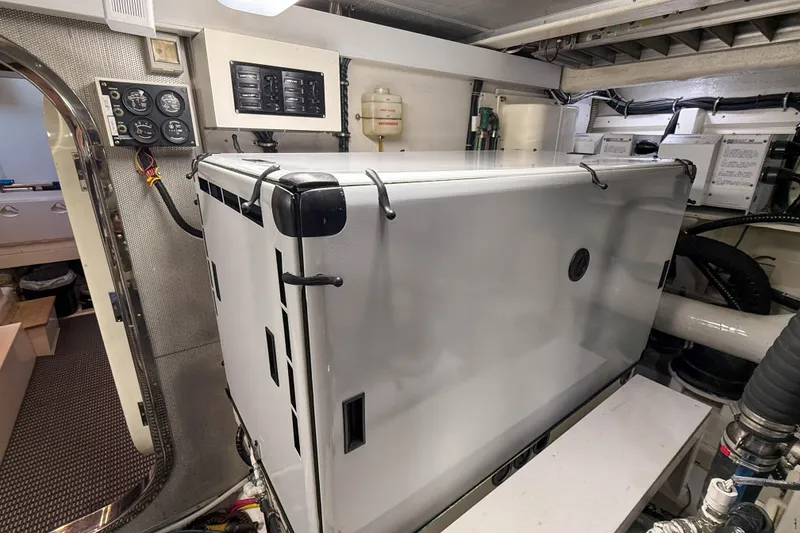 Slide: The Image of Engine room of 2003 Grand Banks 64 Aleutian RP yacht, featuring control panels and equipment. - 82