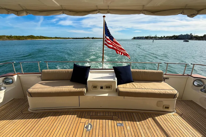 Slide: The Image of Grand Banks 64 Aleutian RP 2003 yacht deck with seating and American flag. - 8
