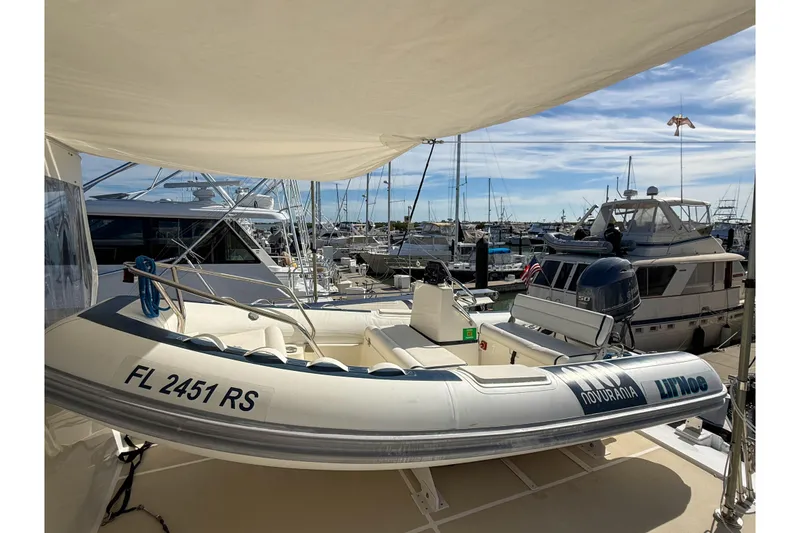 Slide: The Image of Inflatable boat on 2003 Grand Banks 64 Aleutian RP yacht, docked at marina. - 38