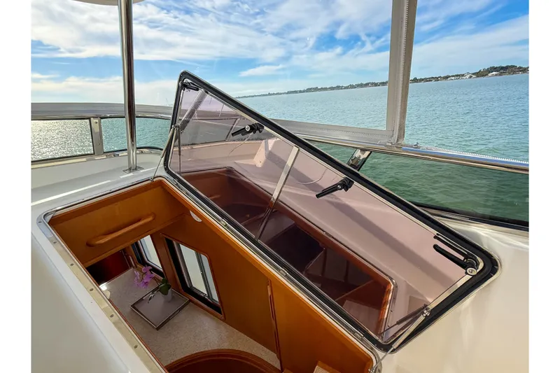 Slide: The Image of Open hatch on 2003 Grand Banks 64 Aleutian RP yacht, overlooking serene water and sky. - 39
