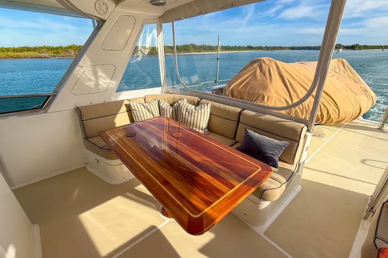Slide: The Image of Luxurious 2003 Grand Banks 64 Aleutian RP yacht interior with elegant wood table and plush seating. - 28