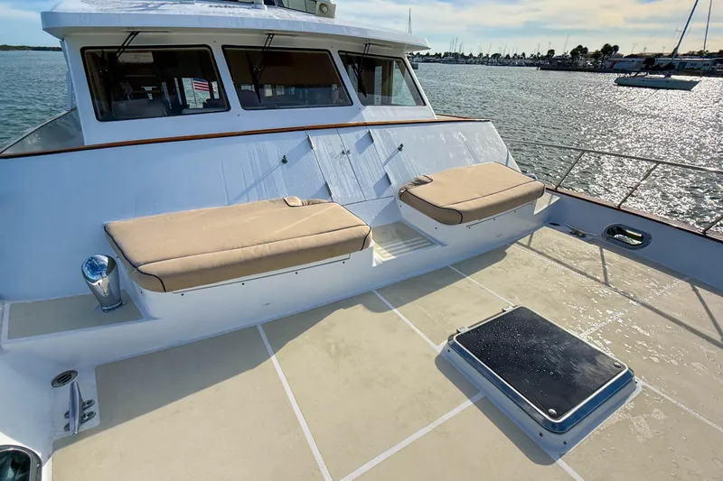 Slide: The Image of 2003 Grand Banks 64 Aleutian RP yacht deck with cushioned seating and ocean view. - 71