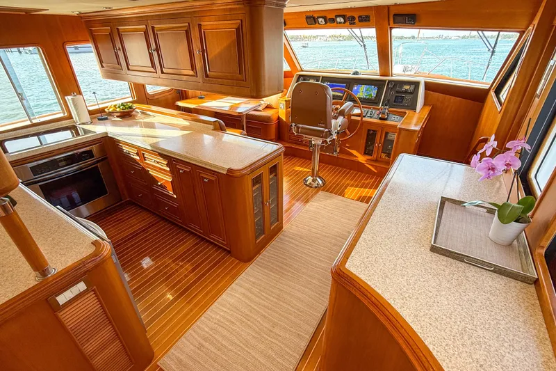 Slide: The Image of Luxurious 2003 Grand Banks 64 Aleutian RP yacht interior with elegant wood finishes and modern navigation. - 14