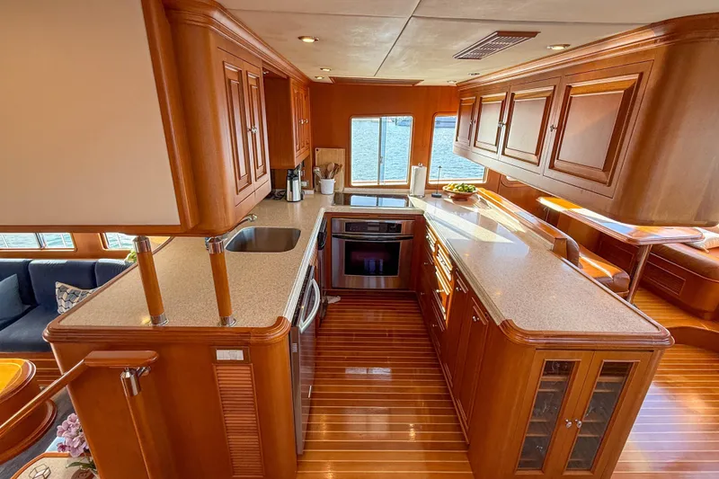 Slide: The Image of Luxurious 2003 Grand Banks 64 Aleutian RP yacht interior with elegant wood cabinetry and modern kitchen. - 15