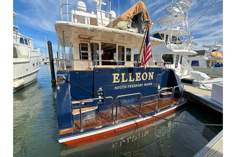 Slide: The Image of 2003 Grand Banks 64 Aleutian RP yacht docked, featuring "ELLEON" and American flag. - 4