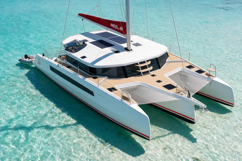 Slide: The Image of Modern NEEL 48 trimaran sailing on clear turquoise waters, 2027 model. - 16
