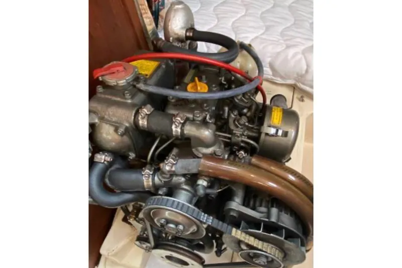 Slide: The Image of Engine of a 1997 Hunter 29.5 sailboat, featuring hoses and belts. - 14