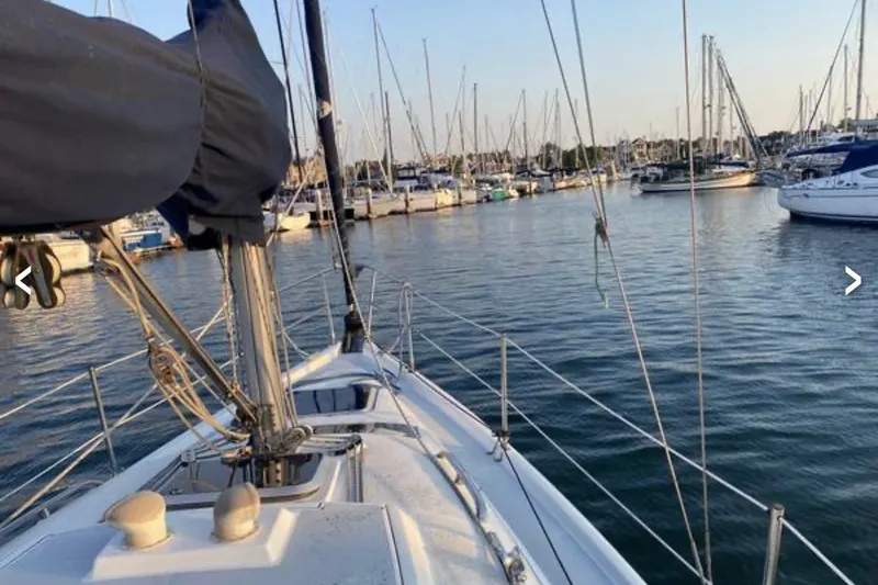 Slide: The Image of Sailboat Hunter 29.5 (1997) docked in a marina with numerous other boats. - 13